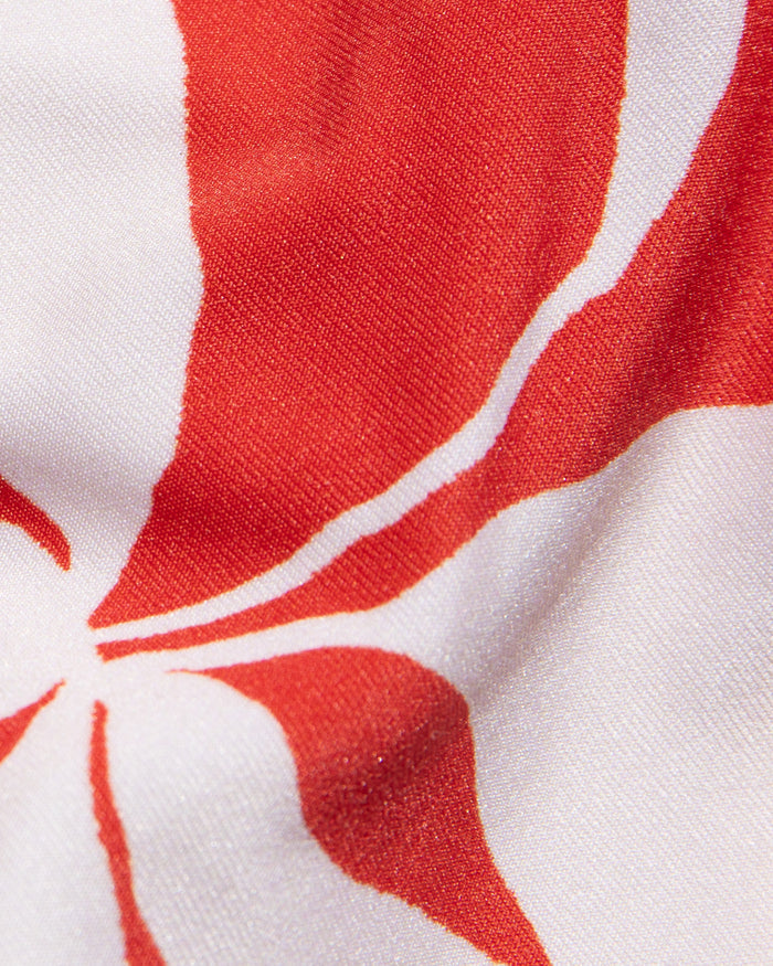 Close-up of red and white hibiscus bloom print fabric used in the LSPACE hibiscus bloom Piper One Piece Swimsuit.