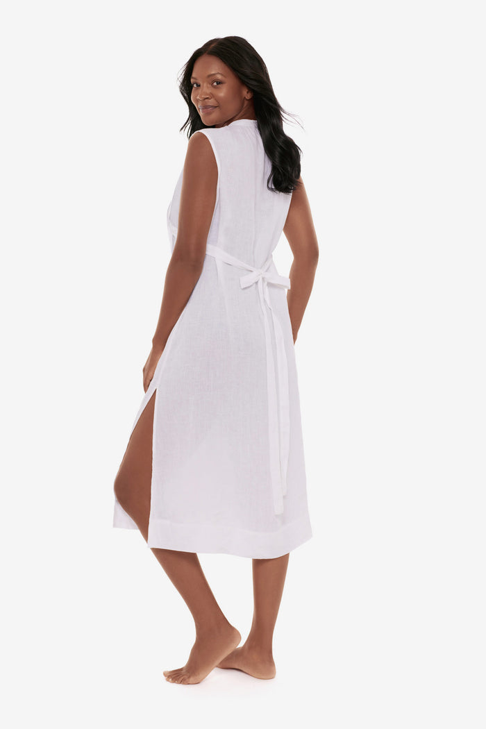Woman turned left wearing a white swim dress cover up