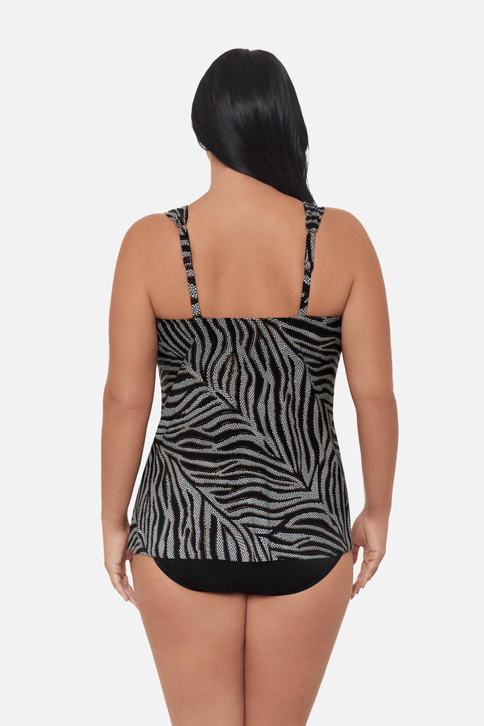 Woman turned away wearing an animal-esque printed tankini top