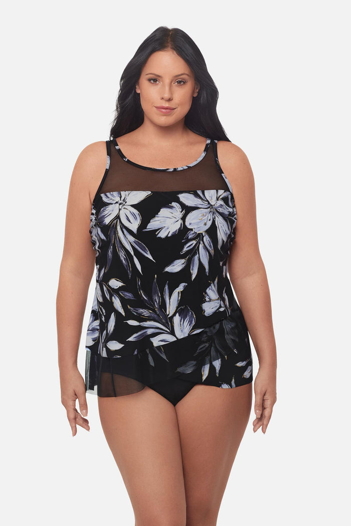 Woman wearing a white floral tankini top with mesh details