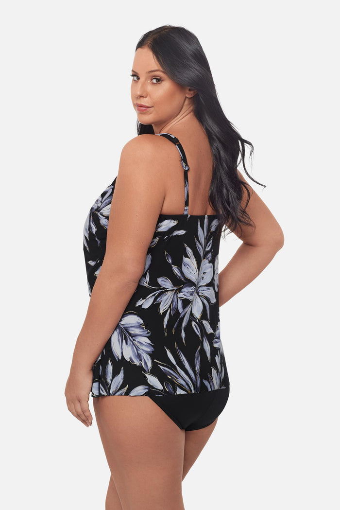 Woman turned left wearing a white floral tankini top with mesh details