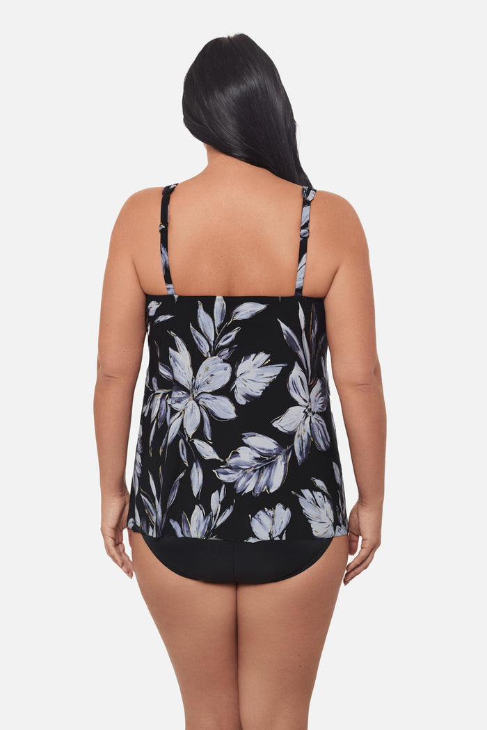 Woman turned away wearing a white floral tankini top
