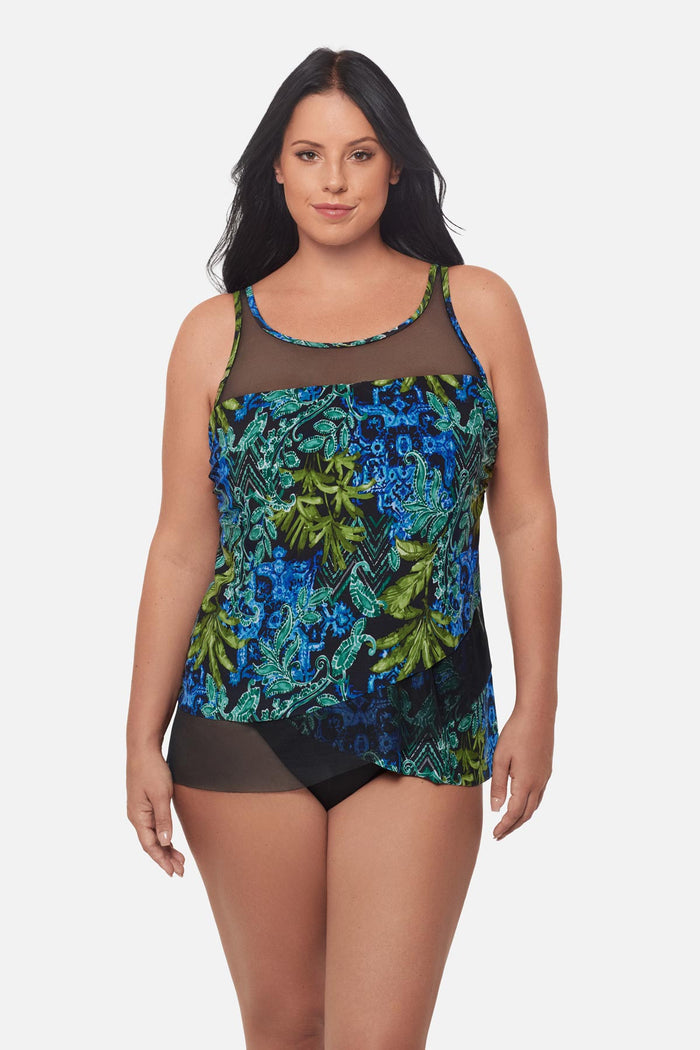 Woman wearing a blue and green abstract print tankini top with mesh details