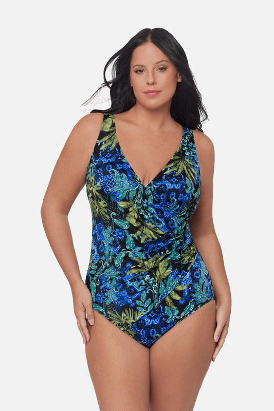 Woman wearing a blue and green abstract printed one-piece swimsuit