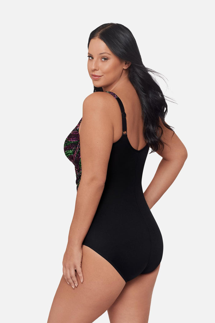 Woman turned left wearing a multicolored dot pattern one-piece swimsuit