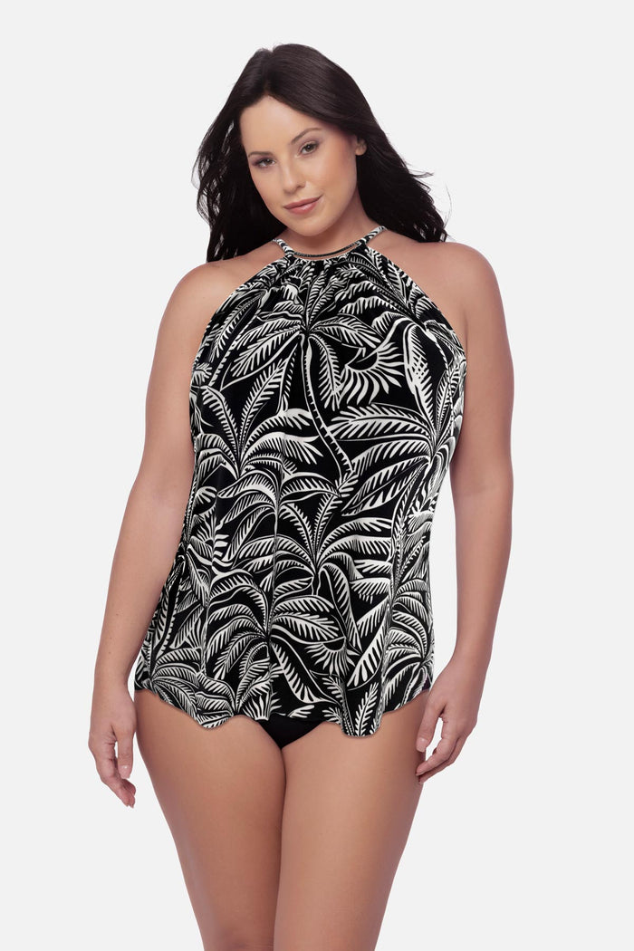 Woman wearing a palm tree printed swim dress with a high neckline