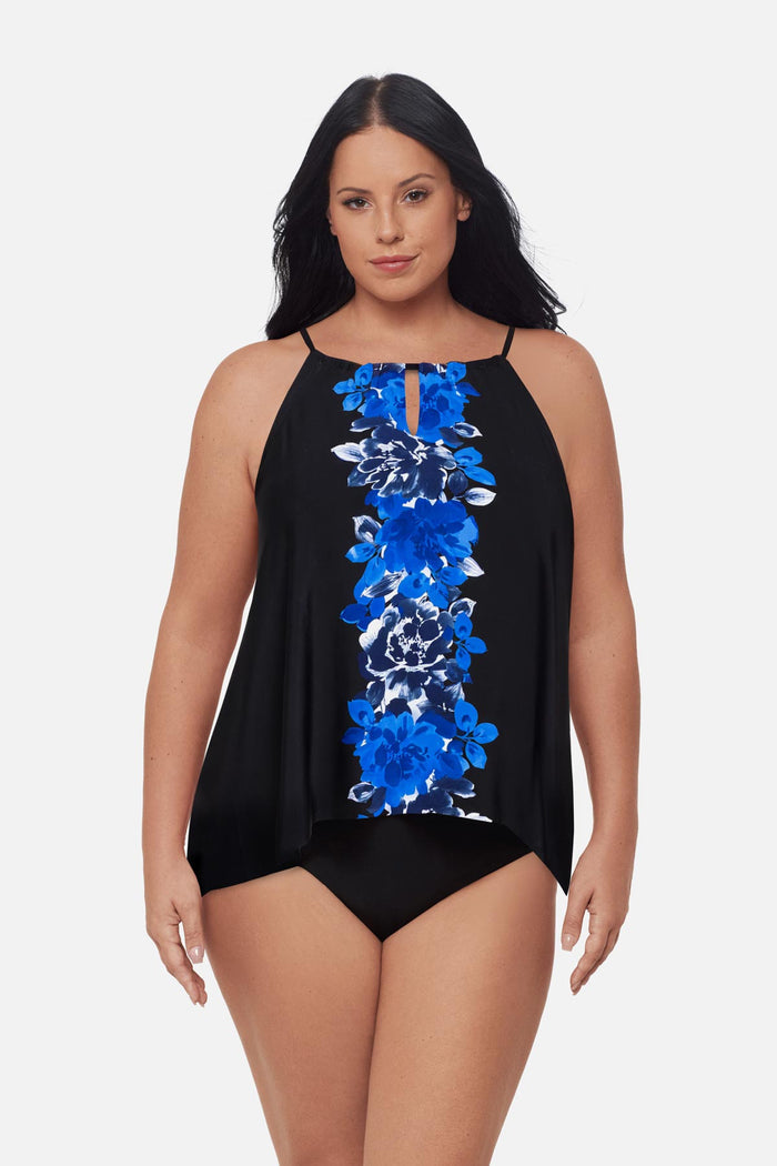 Woman wearing a blue floral printed tankini top with a peep hole neckline