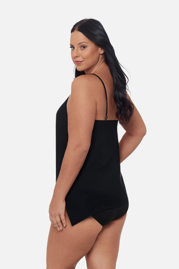 Woman turned left wearing a blue floral printed tankini top with a peep hole neckline