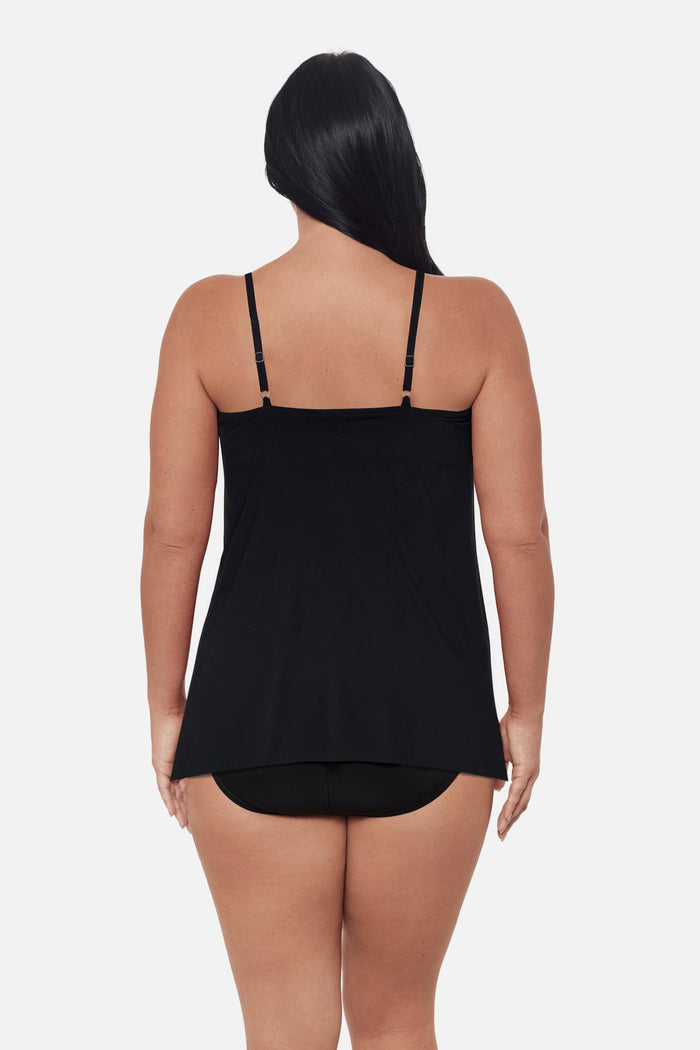 Woman turned away wearing a blue floral printed tankini top with a peep hole neckline