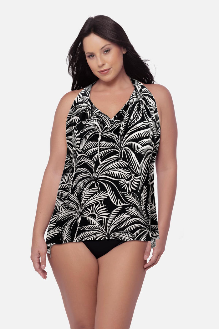 Woman wearing a palm leaf printed tankini top with a v neckline