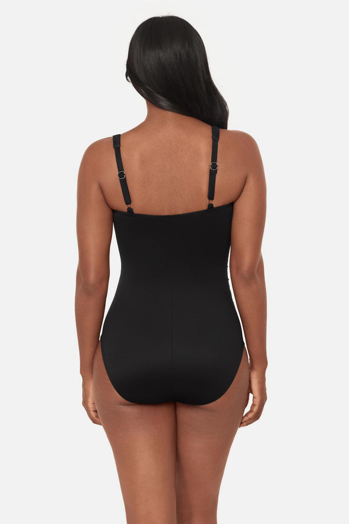 Woman turned away wearing a black square neck one-piece swimsuit