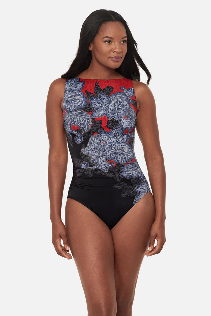 Woman wearing a multicolored abstract floral printed high neck swimsuit