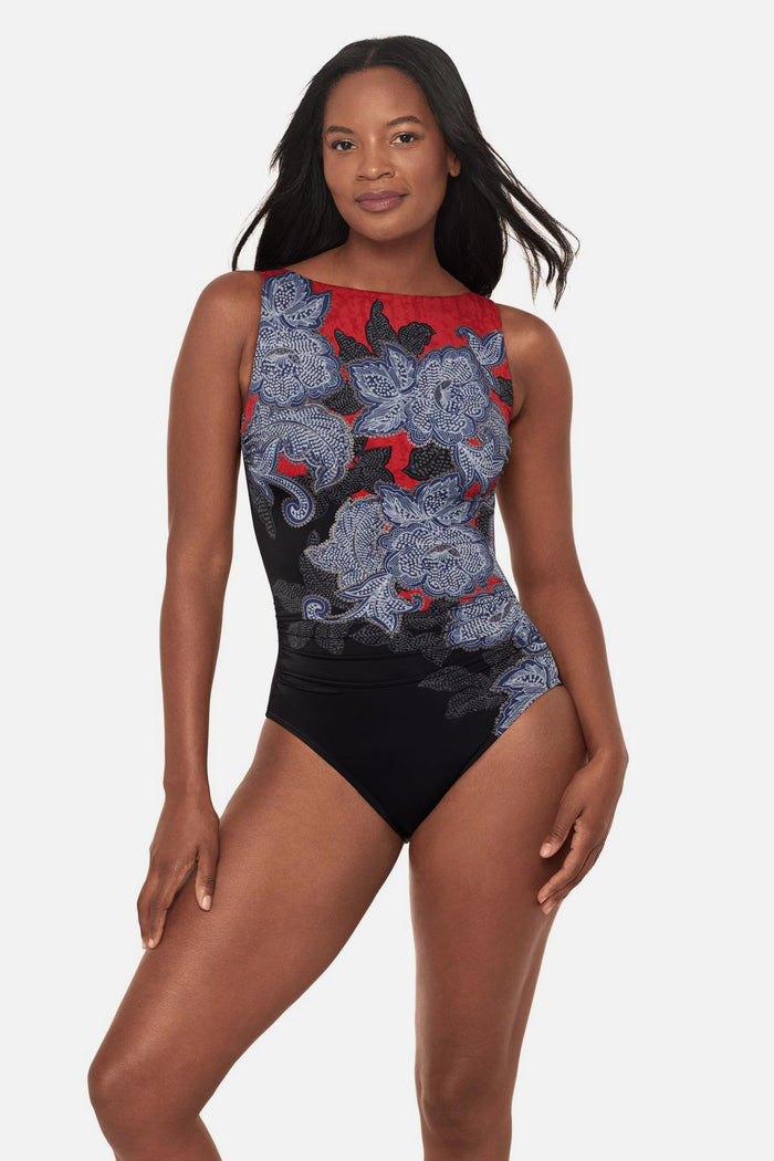 Woman wearing a multicolored abstract floral printed high neck swimsuit
