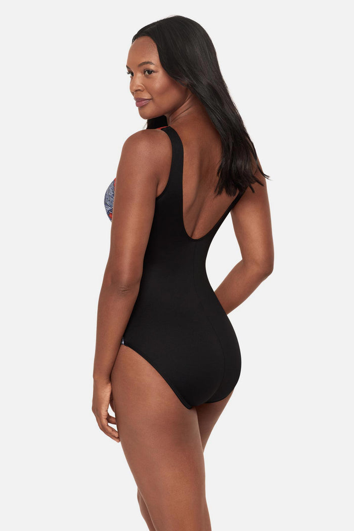 Woman turned left wearing a multicolored abstract floral printed high neck swimsuit