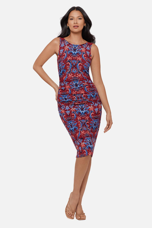 Woman wearing a red and blue paisley-esque sleeveless mid length dress