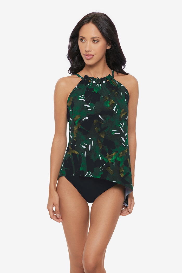 Woman wearing a high neck tankini top with a palm leaf print
