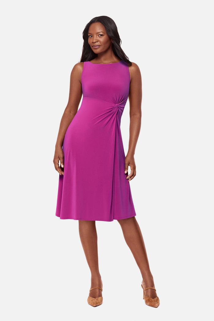 Woman wearing a pink dress with ruching on the side