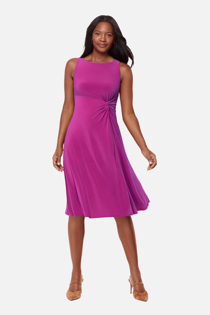 Woman wearing a pink dress with ruching on the side