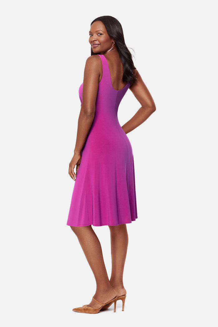 Woman turned left wearing a pink dress with ruching on the side
