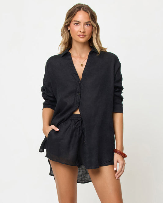 Front view of a model wearing the LSPACE Rio Short in black with a matching rio Tunic in Black.