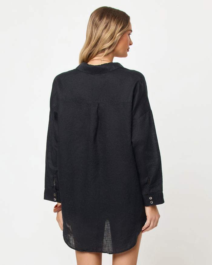 Back view of a model wearing the LSPACE Rio Tunic in black worn long and open.