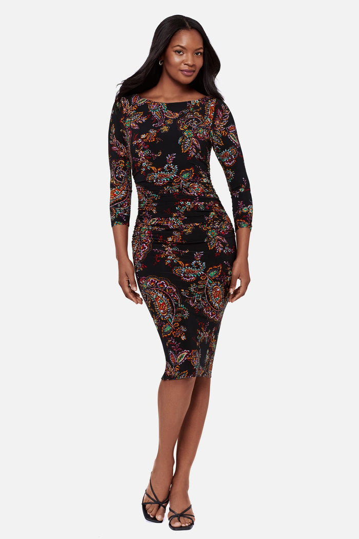 Woman wearing a multicolored paisley print 3/4 sleeve mid length dress