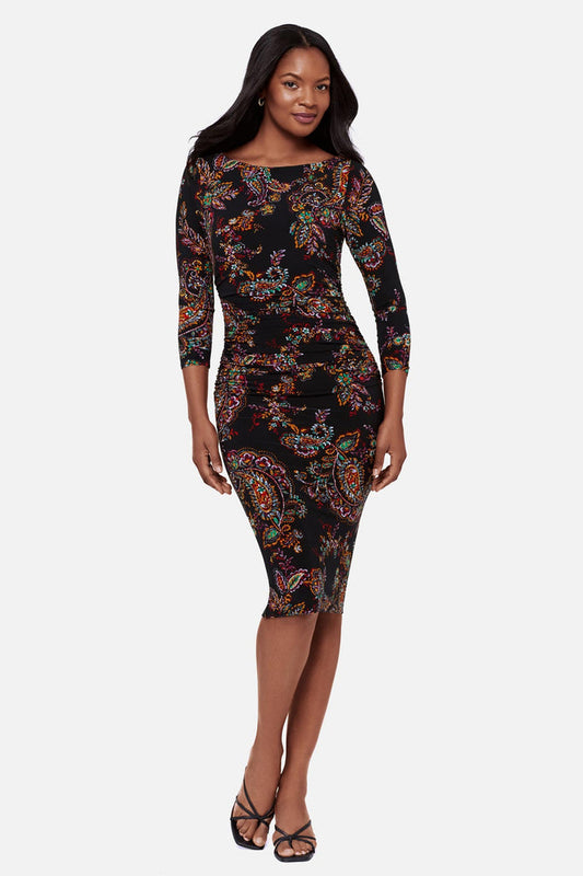 Woman wearing a multicolored paisley print 3/4 sleeve mid length dress