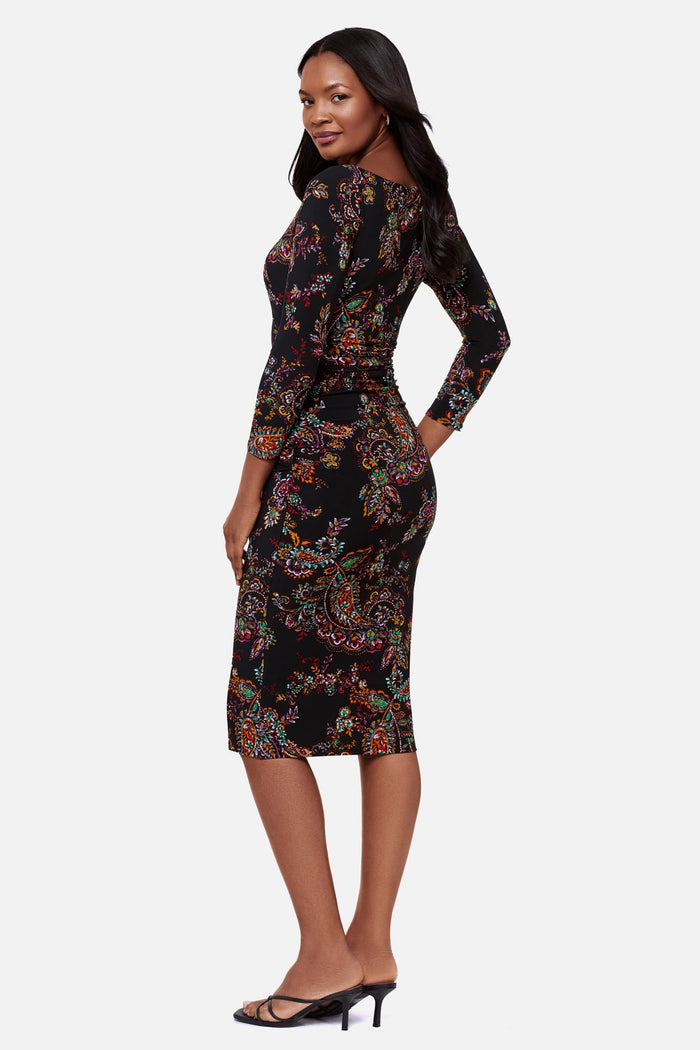 Woman turned left wearing a multicolored paisley print 3/4 sleeve mid length dress