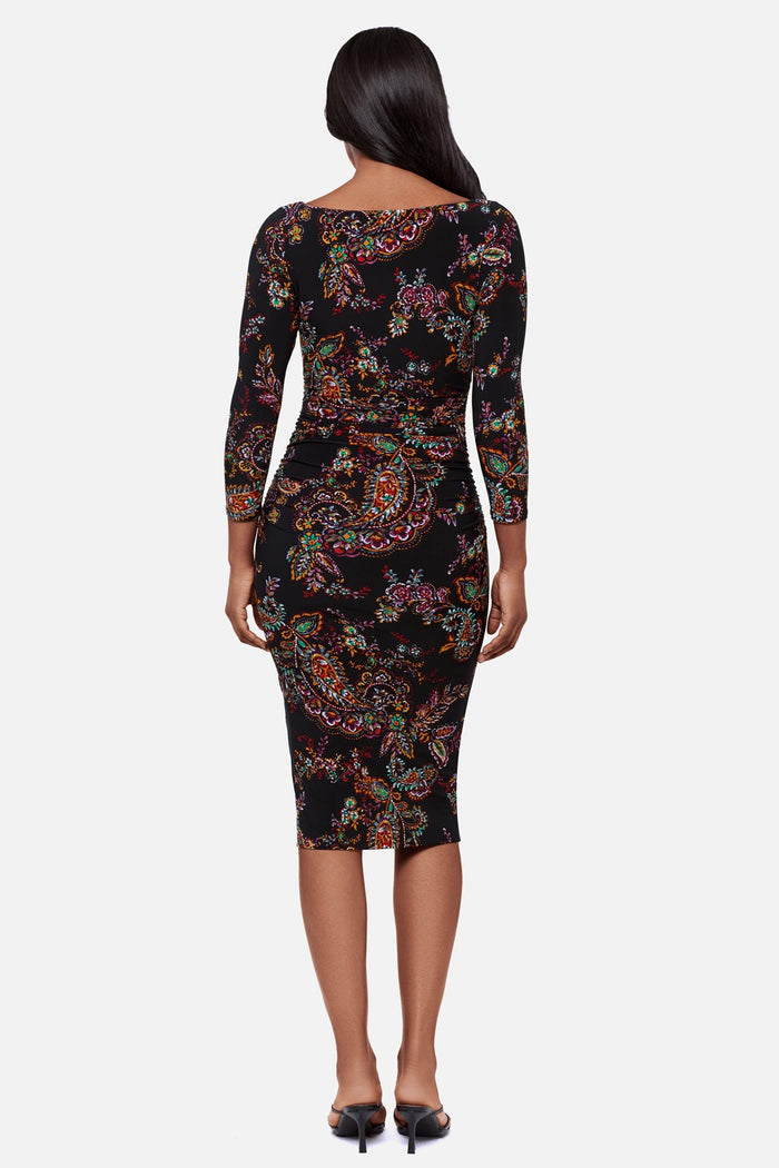 Woman turned away wearing a multicolored paisley print 3/4 sleeve mid length dress
