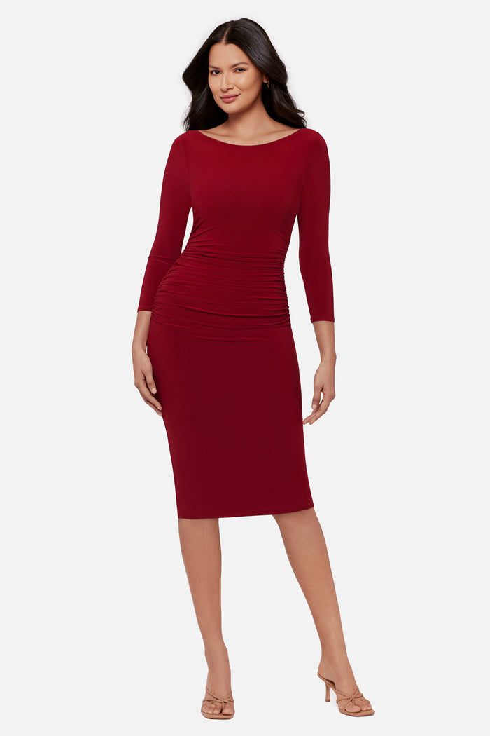 Woman wearing a red 3/4 sleeve mid length dress