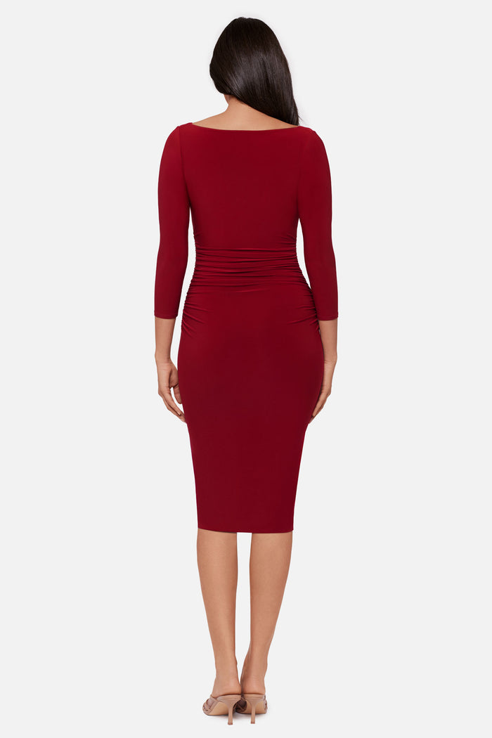 Woman turned away wearing a red 3/4 sleeve mid length dress