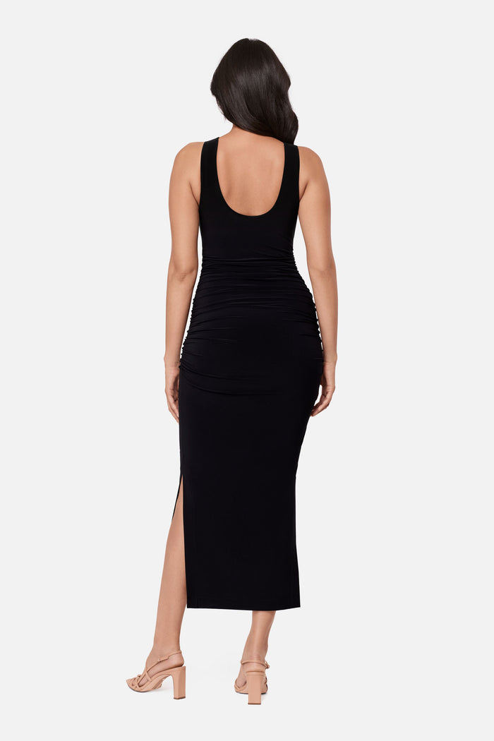 Woman turned away wearing a sleeveless full length black dress