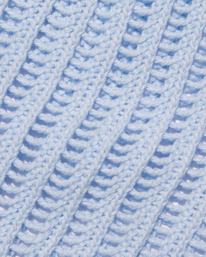 Close-up of the LSPACE Sander Skirt in French blue, showing the open-knit crochet stitch texture and construction detail.