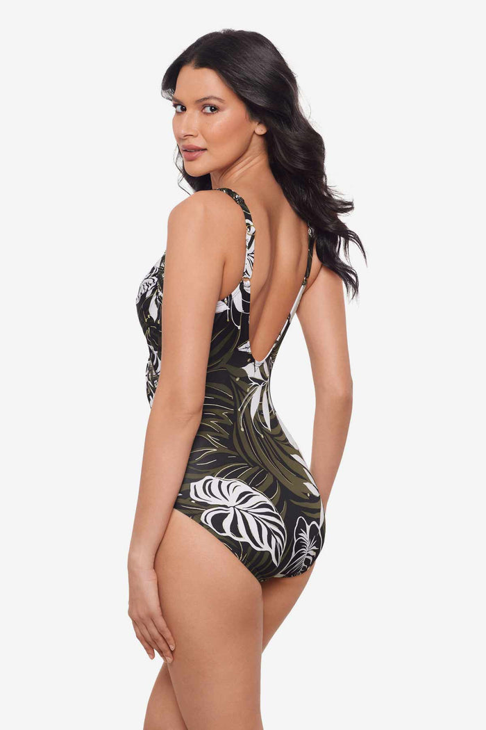 Woman turned to the left to show off the side of the multicolor one-piece swimsuit