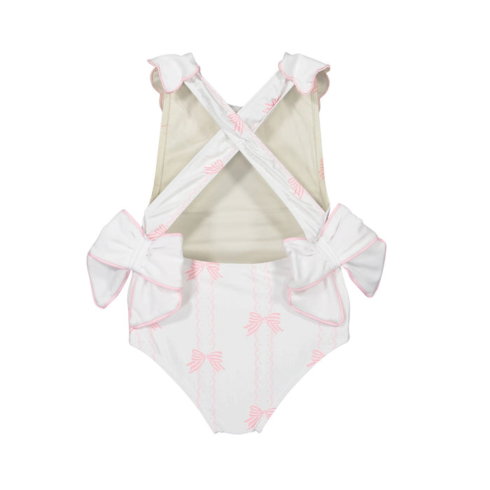 Back view of Scallops and Bows swimsuit with cross-back straps and pink bow print