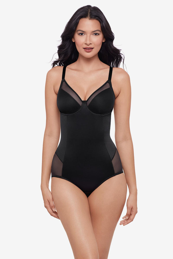Woman wearing black one-piece shapewear