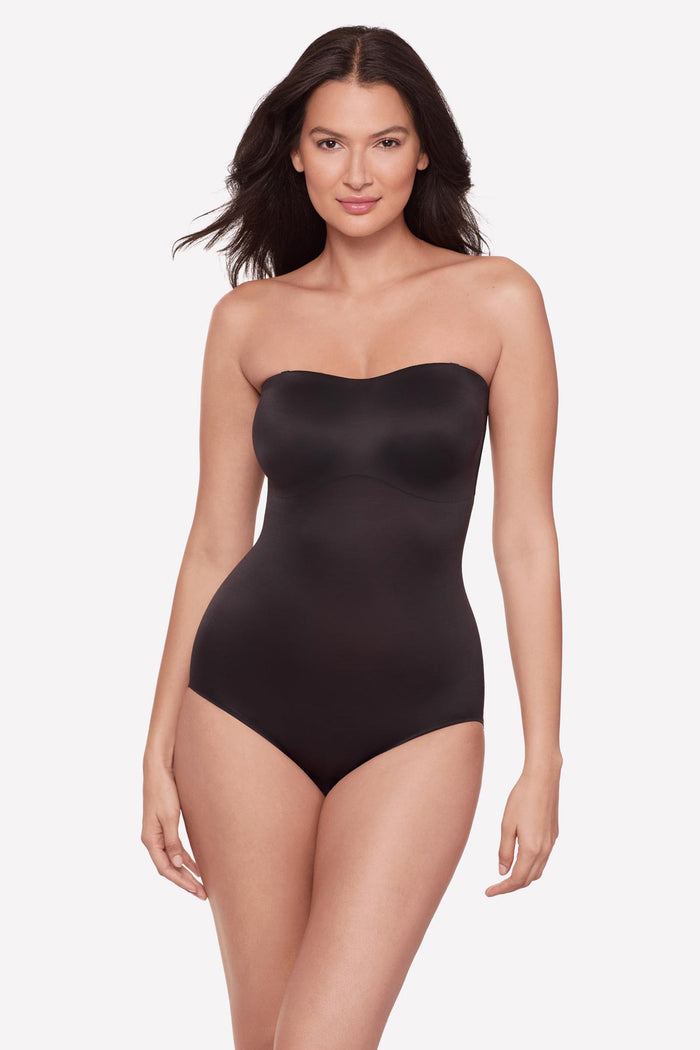 Woman wearing a bandeau style black bodysuit