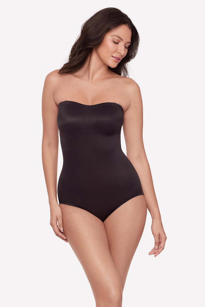 Woman wearing a bandeau style black bodysuit