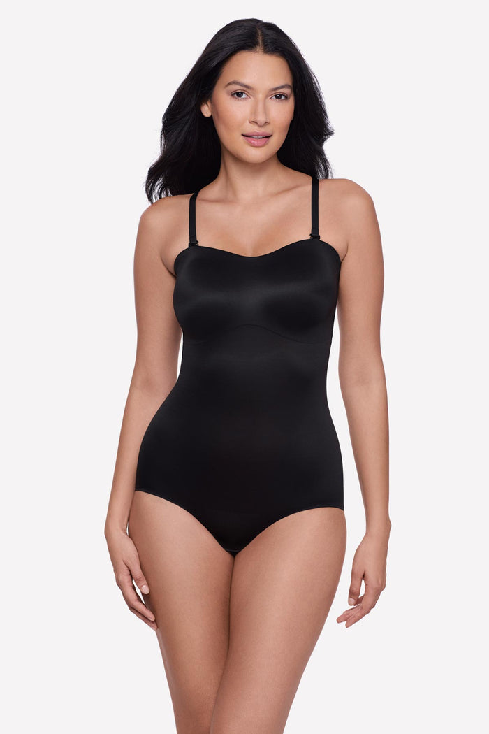 Woman wearing a bandeau style black bodysuit