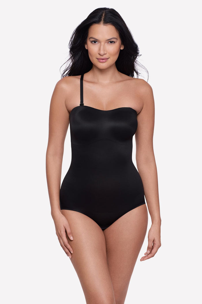 Woman wearing a bandeau style black bodysuit