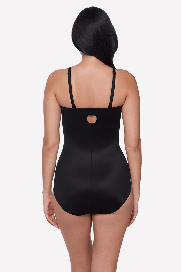 Woman turned away wearing a bandeau style black bodysuit