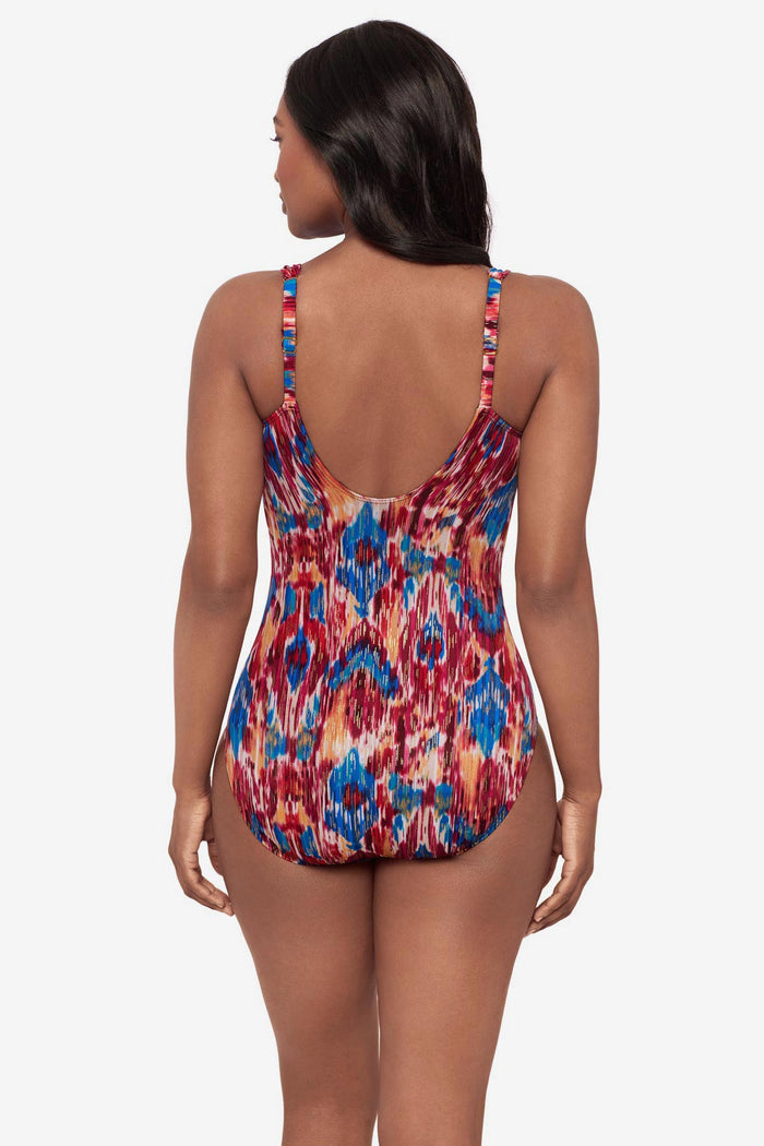 Woman turned away wearing a multicolored one-piece swimsuit