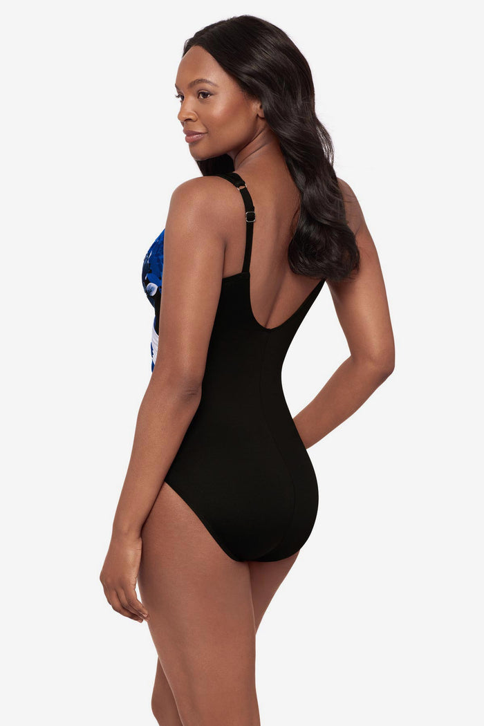 Woman turned left wearing a blue floral printed one-piece swimsuit