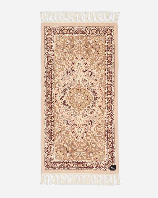 Flat lay of the Slowtide Haven Beach Towel in fawn, showing an ornate Persian medallion pattern in cream and burgundy tones with fringe detail.