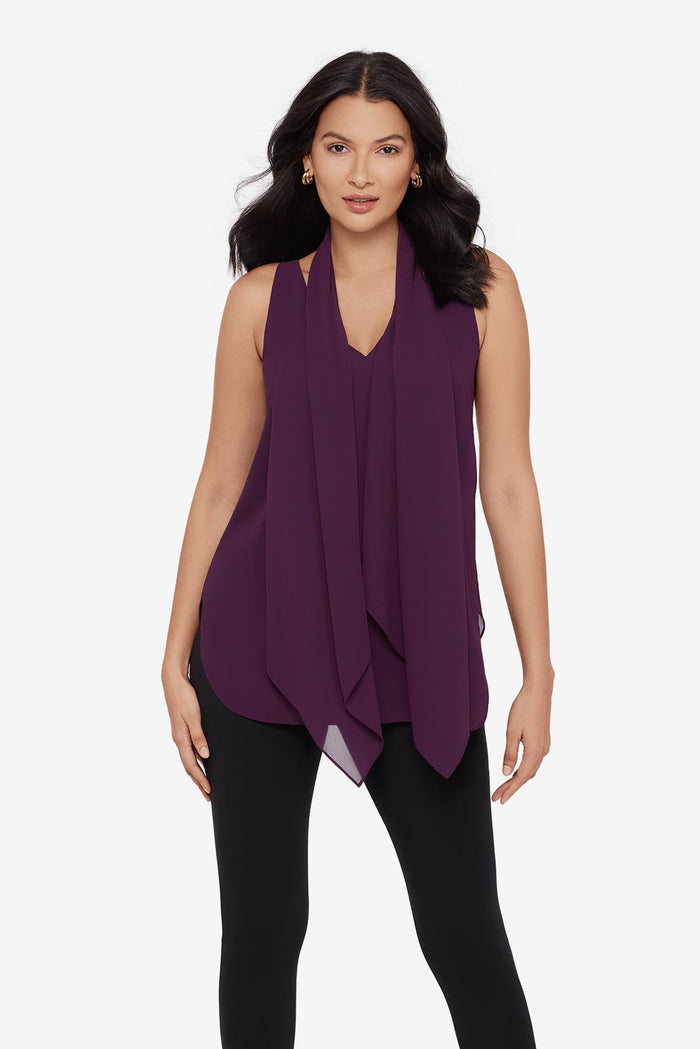 Close up of woman wearing a plum-colored tunic blouse