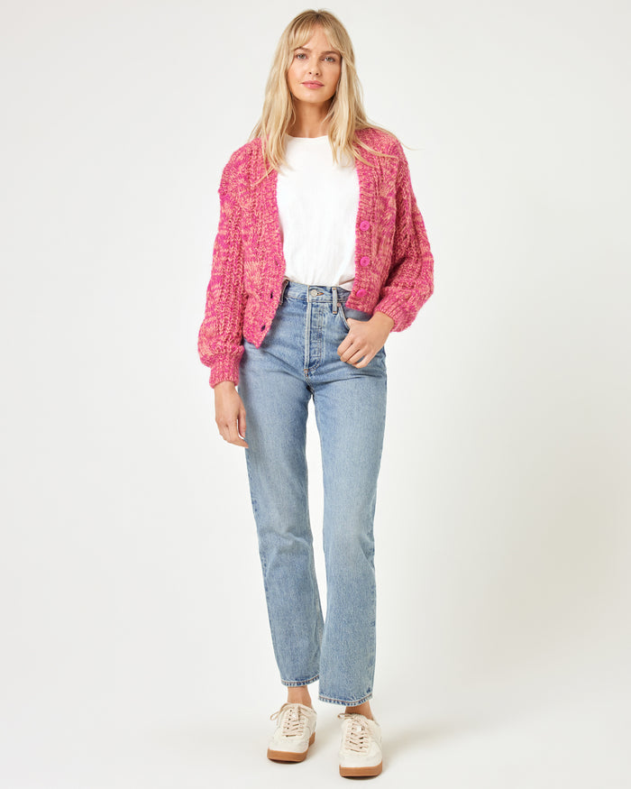 Full-length front view of a model wearing the LSPACE Strawberry Fields Cardigan in strawberry marl, styled open over a white tee with jeans and sneakers on a white background.