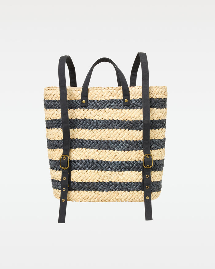 Back view of the Summer Days Backpack in natural-black showing the natural and black stripe woven body and black leather backpack straps.
