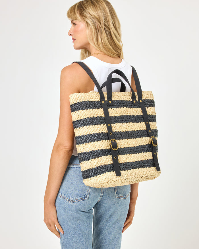Back view of model wearing the Summer Days Backpack in natural-black, paired with a white tank top and jeans.