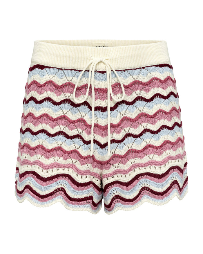 Off-model flat lay of the LSPACE sand in hand Sunchaser Short, crochet knit shorts with a cream drawstring waistband and multicolor wavy stripe pattern in pink, blue, and white, on a white background.