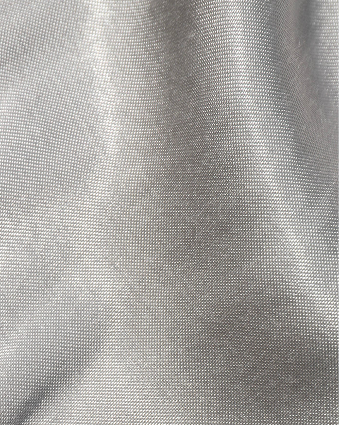 Close-up of the LSPACE Sweet As Honey Skirt in silver, showing the luminous woven satin fabric texture with a metallic silver sheen.